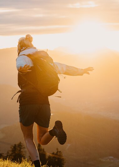 Zwei Wanderer genießen den Sonnenaufgang über den Bergen der Region Hochkönig, voller Abenteuer und Ruhe. | © Hochkönig Tourismus GmbH
