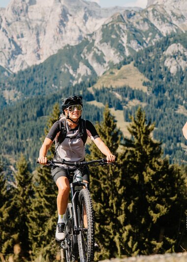 Zwei Radfahrer genießen die Natur beim Biken vor der majestätischen Kulisse des Hochkönigs. | © Hochkönig Tourismus GmbH