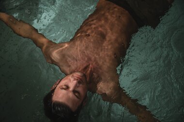 Ein Mann treibt auf der Wasseroberfläche im Pool | © Karin Pasterer
